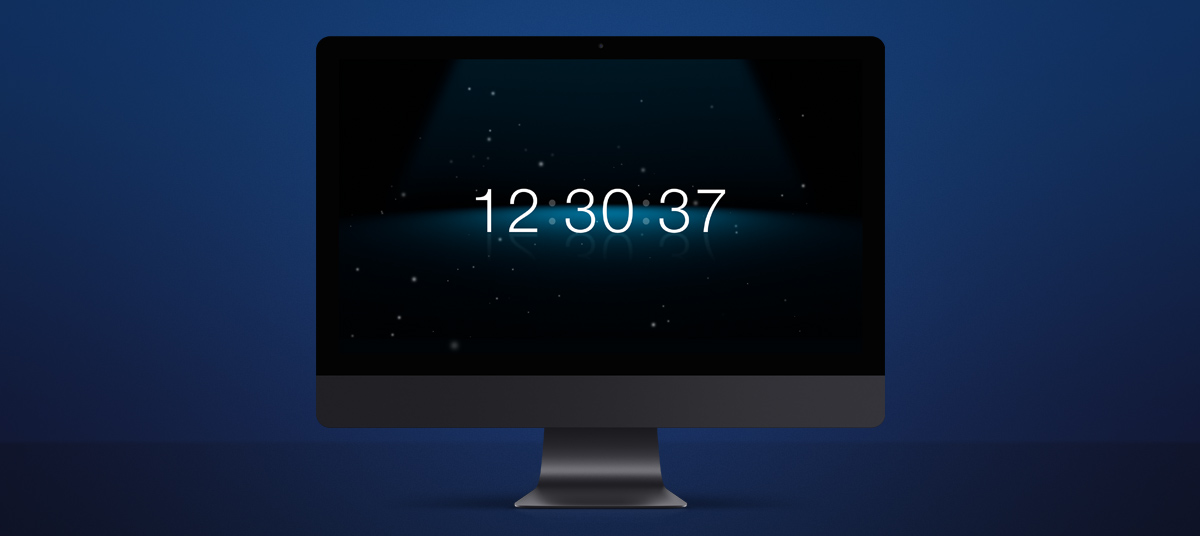 Spotlight clock screensaver on desktop computer.
